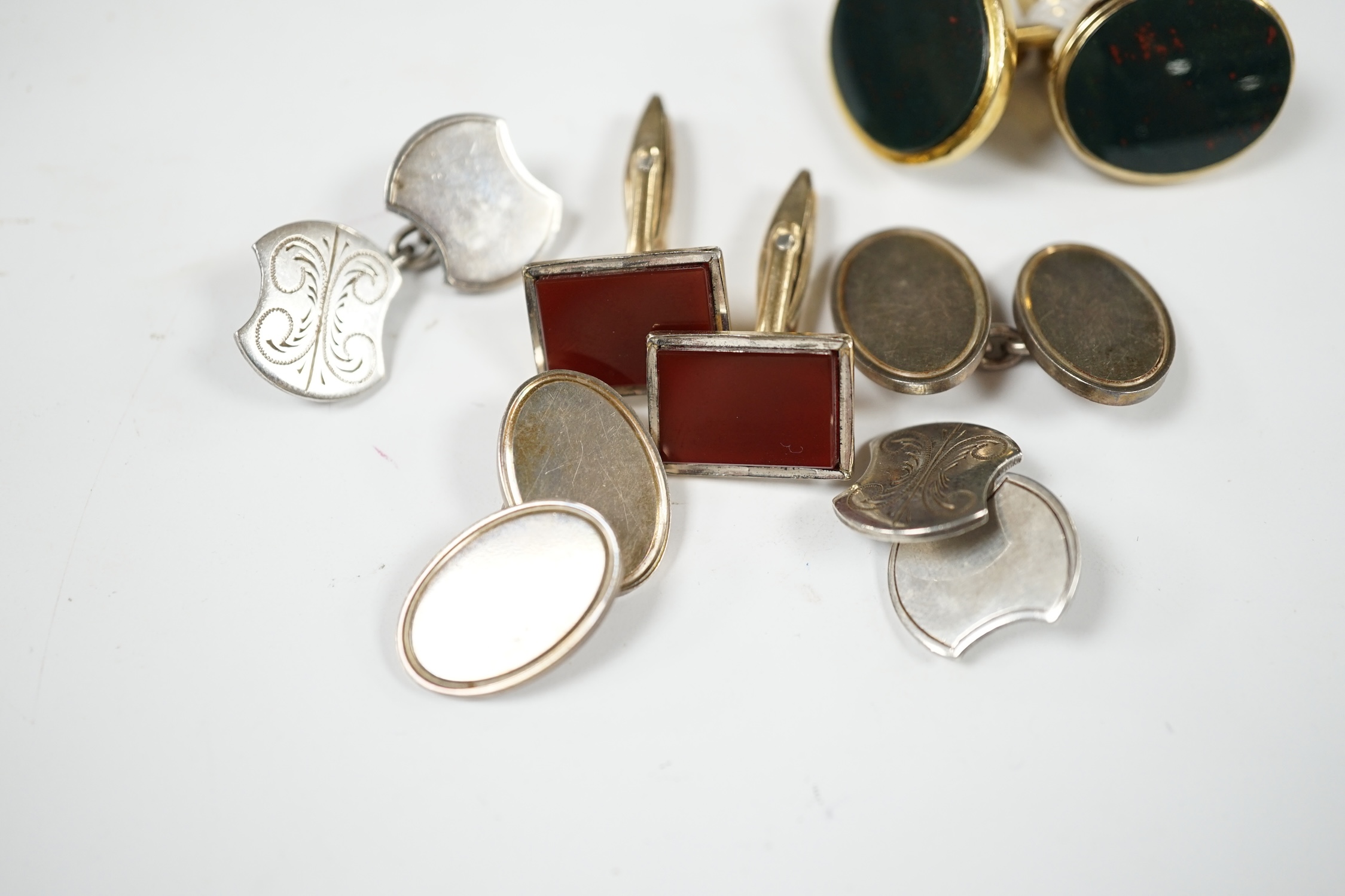 A modern pair of 9ct gold and bloodstone set oval cufflinks, 23mm, gross weight 12.6 grams, together with three other pairs of cufflinks including silver and 'gold on silver'. Condition - fair to good